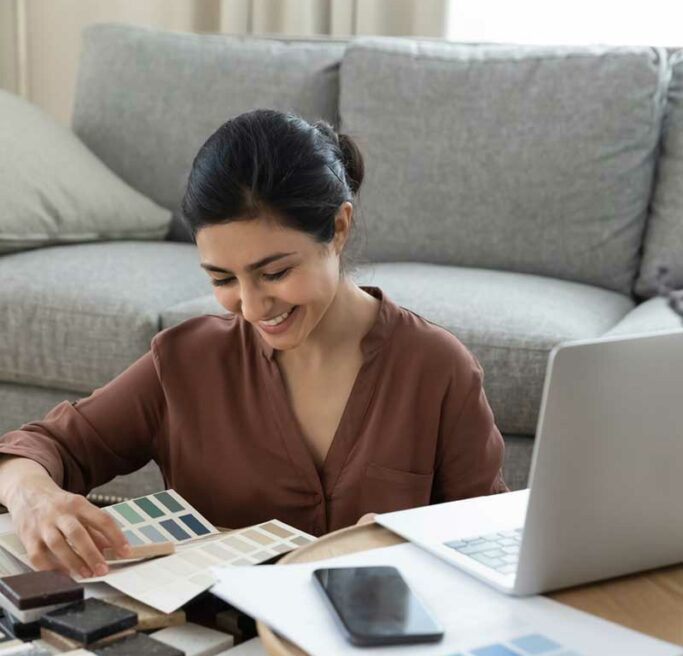 woman-home-remodeling-swatch-selection Woman choosing swatches for home remodel